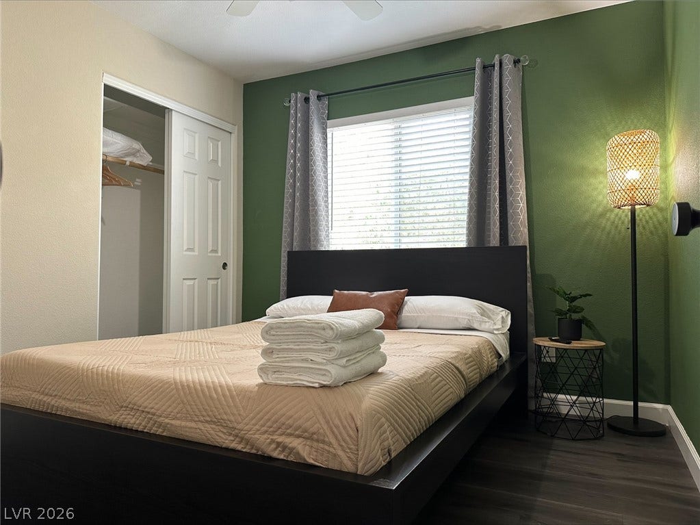 6089 Mustang Breeze Trail, #102, Henderson, NV 89011 Rich wood-look flooring and a classic sliding closet door anchor this comfortable bedroom space.