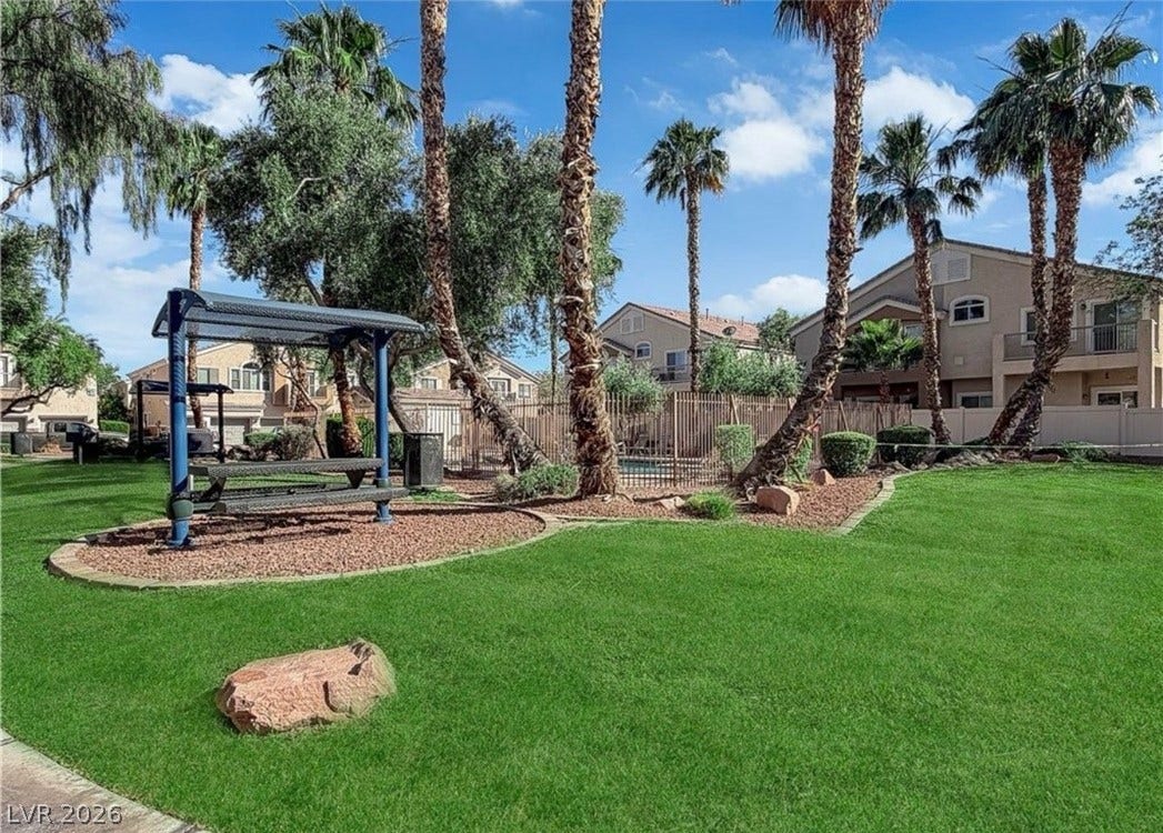 6089 Mustang Breeze Trail, #102, Henderson, NV 89011 Lush green lawns and towering palm trees surround the inviting community recreation areas.