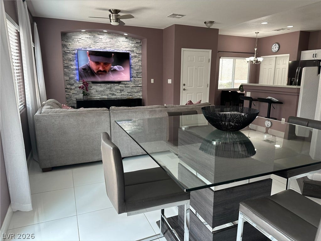6089 Mustang Breeze Trail, #102, Henderson, NV 89011 Gleaming tile floors and a stone-accented media niche define this modern open-concept living space.