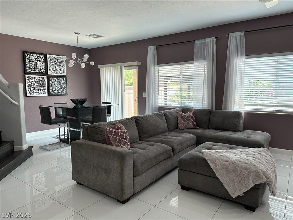 6089 Mustang Breeze Trail, #102, Henderson, NV 89011 Polished tile flooring and expansive windows define this versatile open living and dining layout.