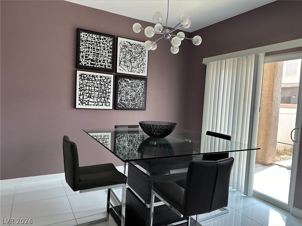 6089 Mustang Breeze Trail, #102, Henderson, NV 89011 Sliding glass doors open to the outdoors from a modern dining area with tile flooring.