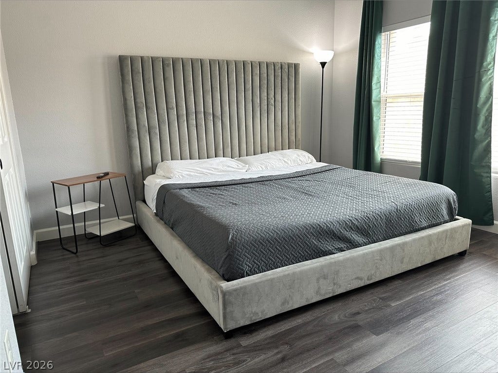 6089 Mustang Breeze Trail, #102, Henderson, NV 89011 Rich wood plank flooring sets a warm foundation in this comfortable bedroom space.