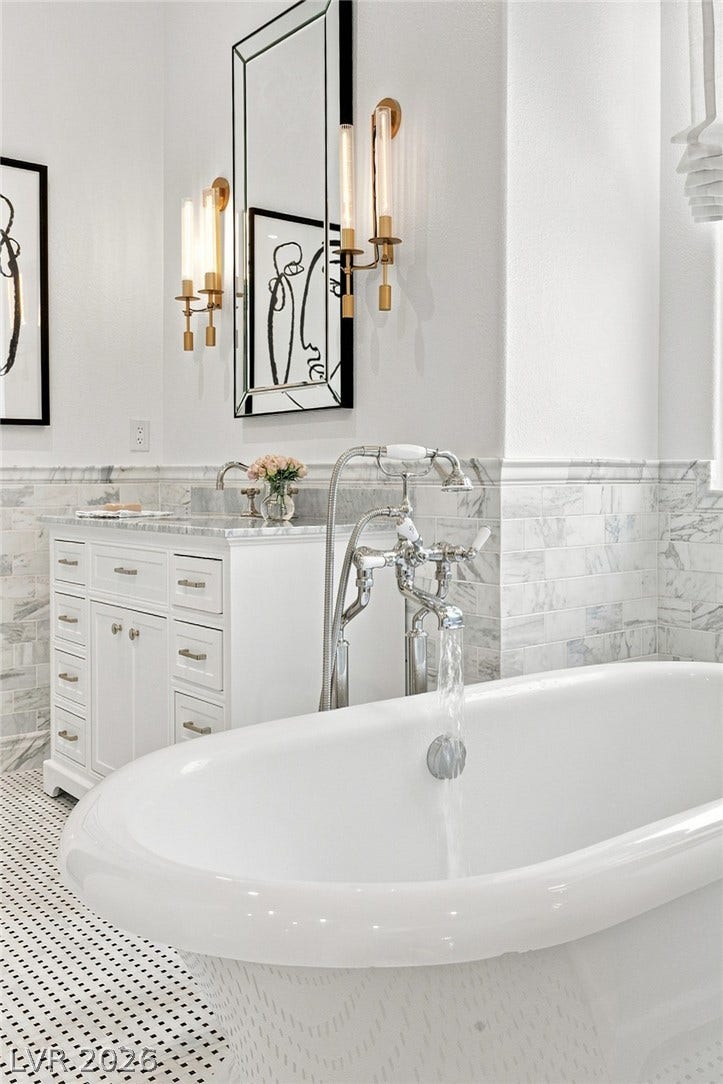 8 Pine Hollow Drive, Henderson, NV 89052 Elegant marble tiling and a soaking tub define this master bath retreat.