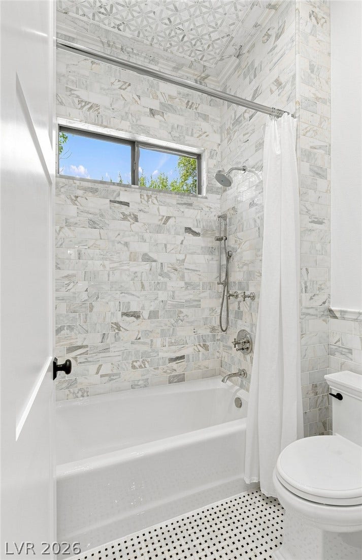 8 Pine Hollow Drive, Henderson, NV 89052 Custom marble tiling spans the shower surround above a classic mosaic floor.
