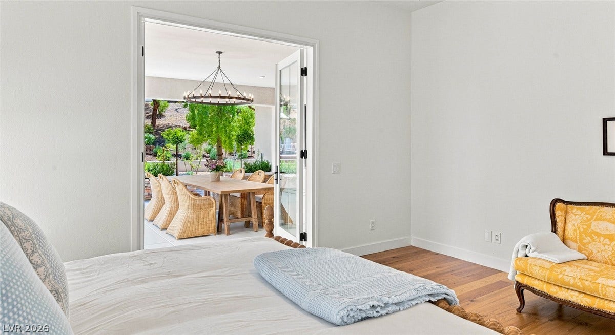 8 Pine Hollow Drive, Henderson, NV 89052 Double glass doors open directly from the bedroom to an inviting outdoor terrace.