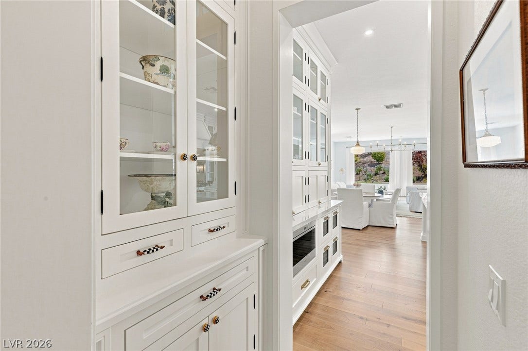 8 Pine Hollow Drive, Henderson, NV 89052 Custom built-in cabinetry frames a bright hallway butler's pantry area that leads into the kitchen