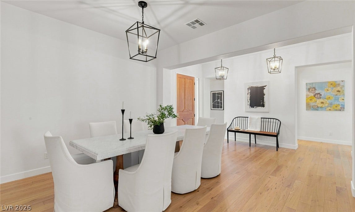 8 Pine Hollow Drive, Henderson, NV 89052 Hardwood floors and crisp, warm-white walls define this open dining space.