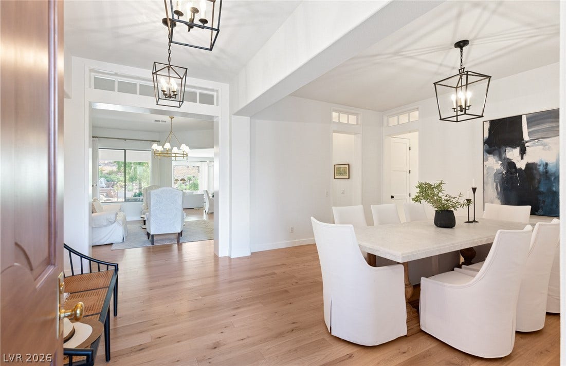 8 Pine Hollow Drive, Henderson, NV 89052 An open dining room flows seamlessly into adjoining spaces over light hardwood flooring.