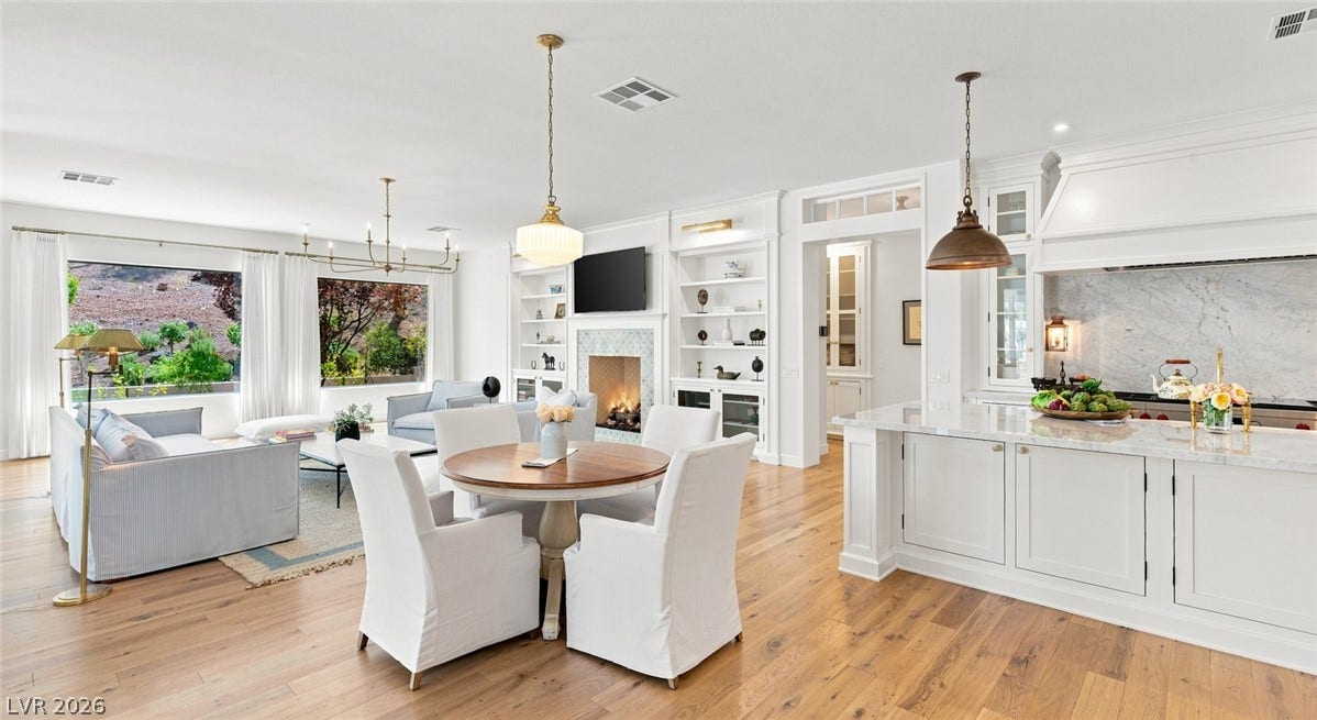 8 Pine Hollow Drive, Henderson, NV 89052 An open floor plan seamlessly connects the kitchen and dining area, with natural wood floors throughout.