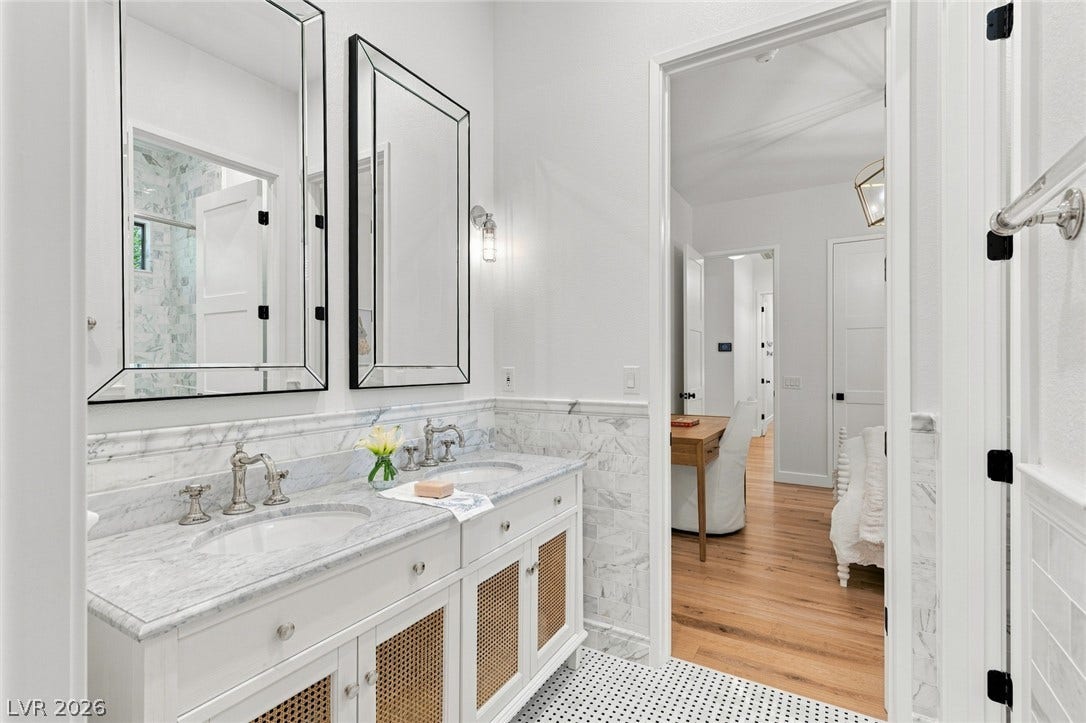 8 Pine Hollow Drive, Henderson, NV 89052 Fine marble counters and intricate tile flooring elevate the bathroom space.