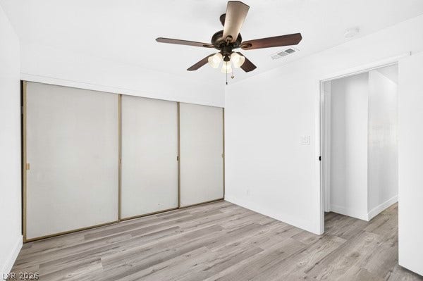 4284 Annie Oakley Drive, Las Vegas, NV 89121 Crisp walls and modern plank flooring define this clean, versatile bedroom space.