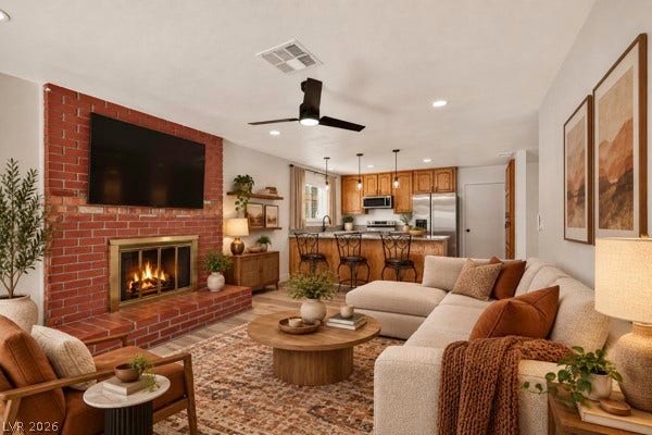 4284 Annie Oakley Drive, Las Vegas, NV 89121 An inviting brick fireplace anchors the open-concept living area with seamless kitchen access.
