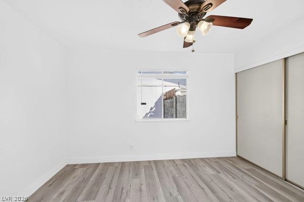 4284 Annie Oakley Drive, Las Vegas, NV 89121 Smooth wood-style flooring anchors this light-filled room with sliding closet doors.