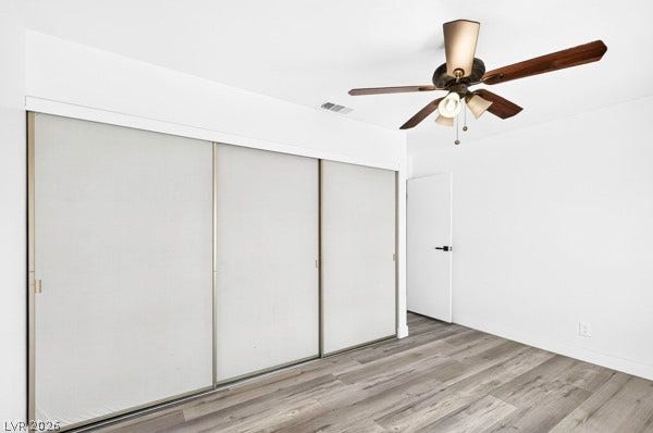 4284 Annie Oakley Drive, Las Vegas, NV 89121 Sleek wood-style flooring runs through this light-filled room featuring sliding closet doors.