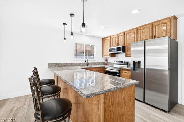4284 Annie Oakley Drive, Las Vegas, NV 89121 Polished granite countertops complement warm oak cabinetry in this functional, open culinary space.