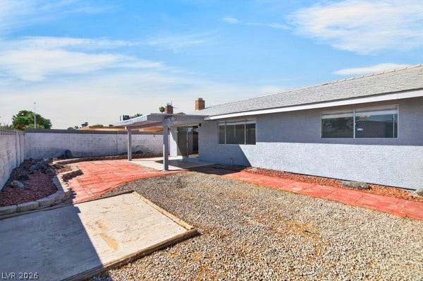 4284 Annie Oakley Drive, Las Vegas, NV 89121 An inviting covered patio highlights this spacious back yard featuring a low-maintenance gravel design.