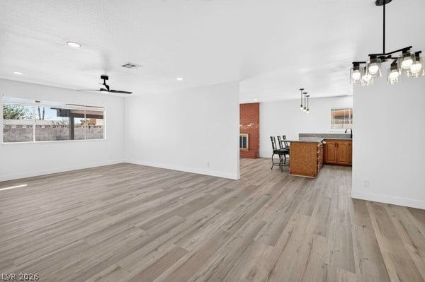 4284 Annie Oakley Drive, Las Vegas, NV 89121 Smooth wood floors flow seamlessly through this open-concept layout connecting the living area and kitchen.