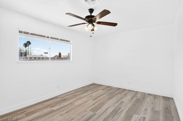 4284 Annie Oakley Drive, Las Vegas, NV 89121 Smooth wood-look flooring and a wide window define this versatile interior space.