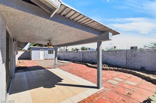 4284 Annie Oakley Drive, Las Vegas, NV 89121 A spacious covered patio overlooks a private, low-maintenance backyard enclosed by brick fencing.