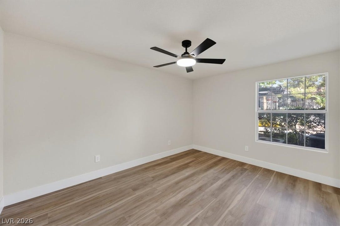 2606 S Durango Drive, #128, Las Vegas, NV 89117 Smooth wood-style flooring and a multi-pane window enhance this versatile interior room.