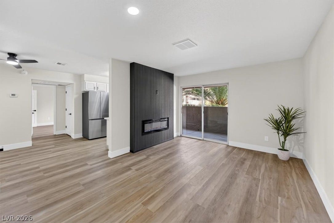 2606 S Durango Drive, #128, Las Vegas, NV 89117 A modern electric fireplace anchors this open living area featuring durable wood-look flooring.