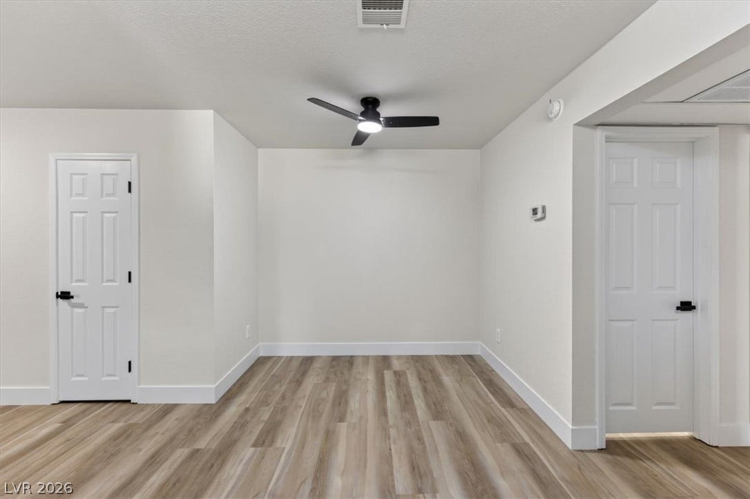 2606 S Durango Drive, #128, Las Vegas, NV 89117 Gleaming wood-look floors pair with crisp white walls in this versatile bonus space.