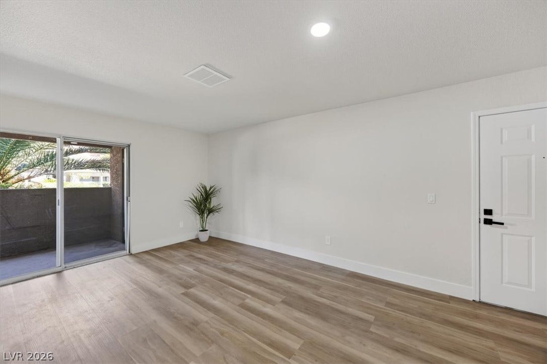 2606 S Durango Drive, #128, Las Vegas, NV 89117 Warm wood flooring grounds this airy living space opening directly to a private balcony.