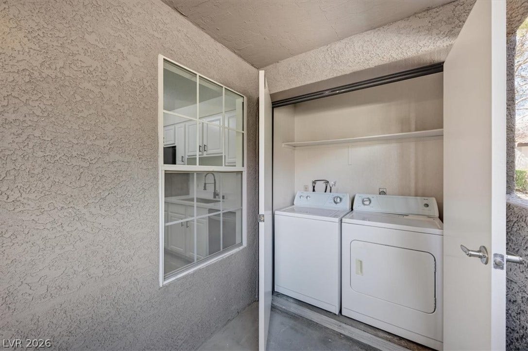 2606 S Durango Drive, #128, Las Vegas, NV 89117 An outdoor utility closet reveals a dedicated laundry setup complete with built-in storage shelving.