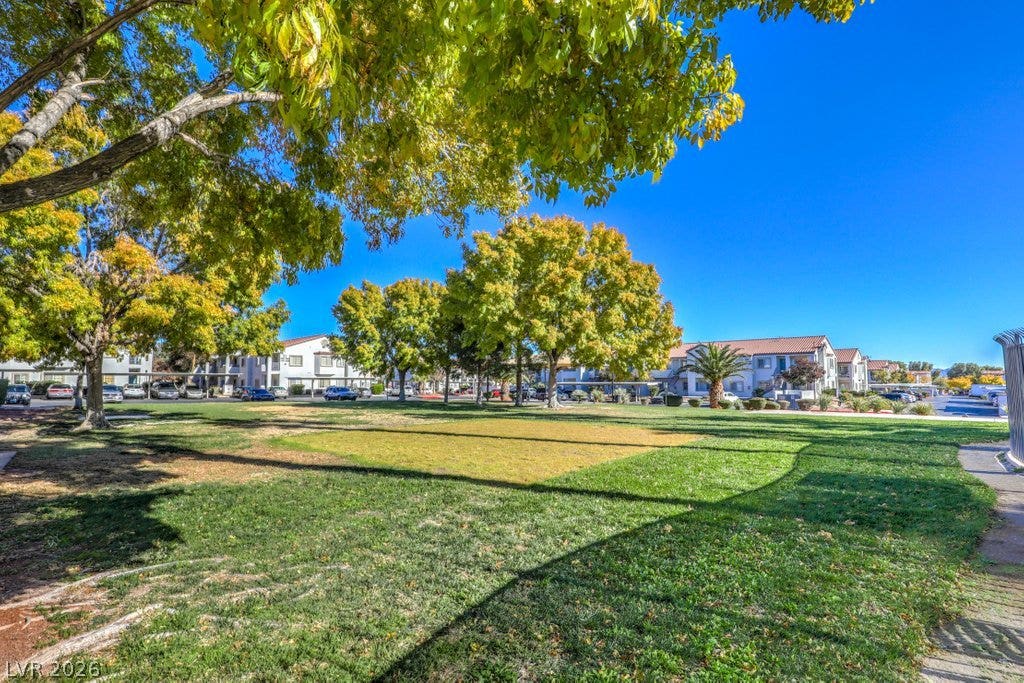 3318 N Decatur Boulevard, #2142, Las Vegas, NV 89130 Mature trees shade a spacious green lawn within the residential community.