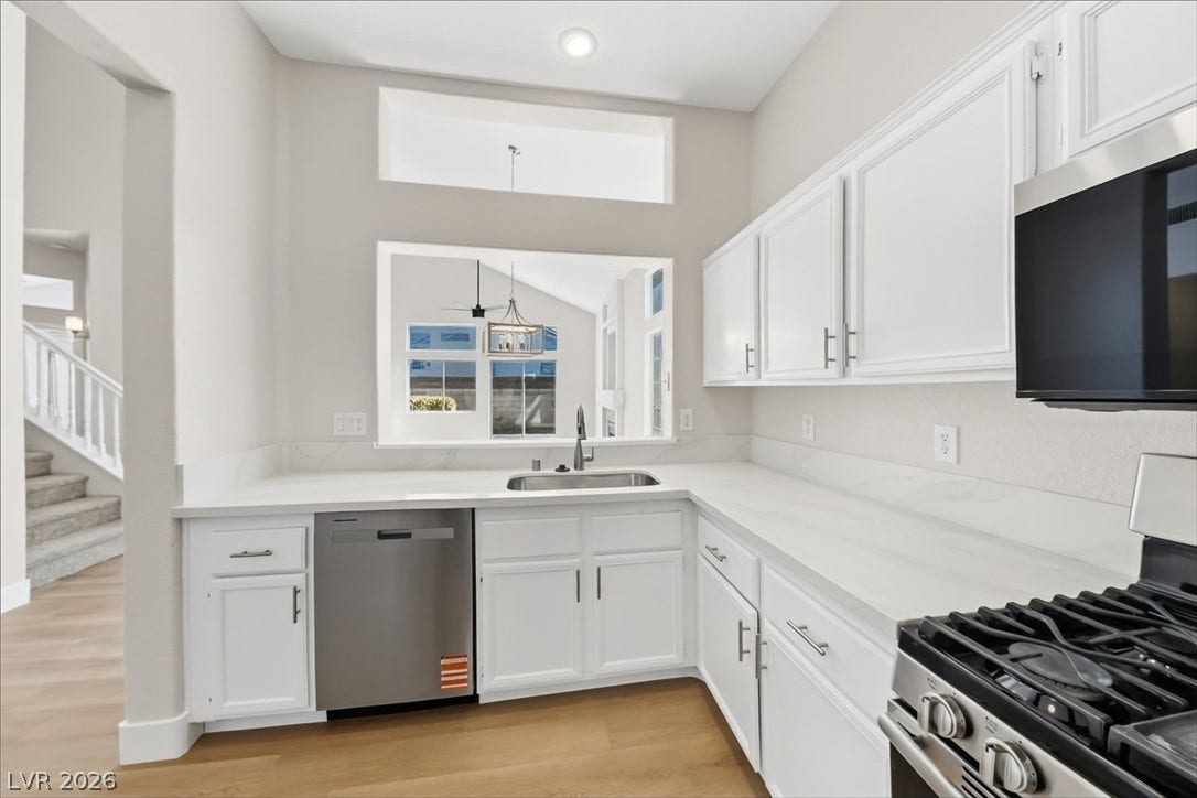 1906 Cardinal Point Street, Henderson, NV 89012 High ceilings and a cut-out window overlook the adjacent dining area from the kitchen.