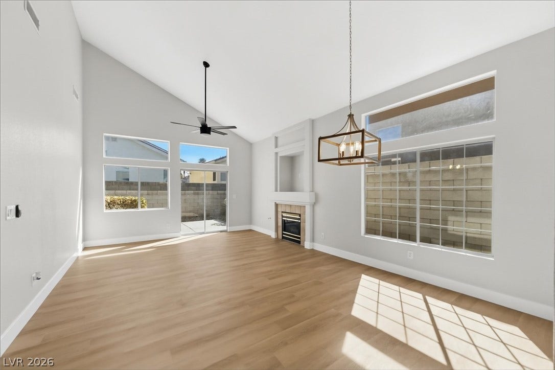 1906 Cardinal Point Street, Henderson, NV 89012 Soaring vaulted ceilings and warm wood floors define this light-filled living area.