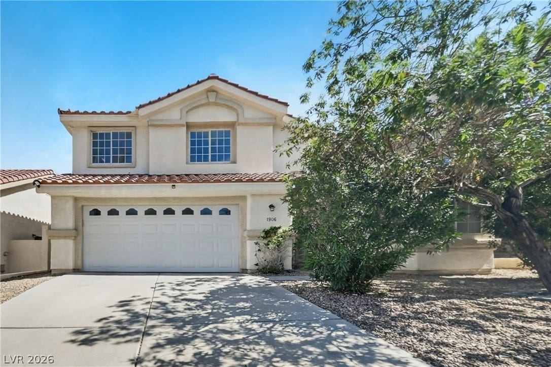 1906 Cardinal Point Street, Henderson, NV 89012 Spanish tile roofing and classic stucco exterior define this two-story residential facade.