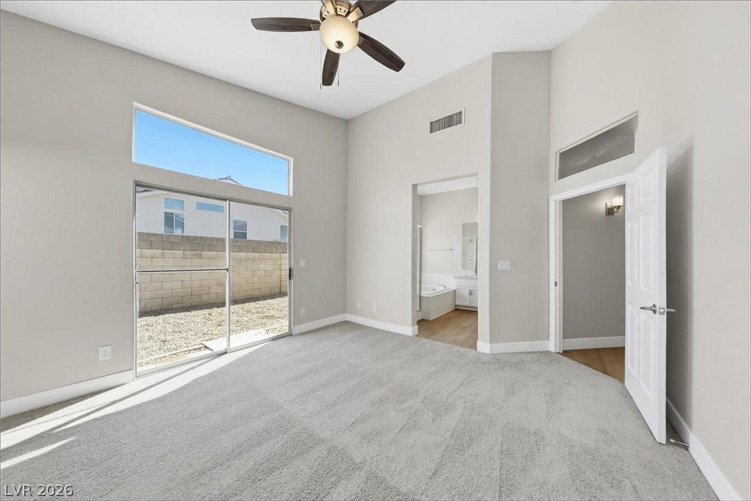 1906 Cardinal Point Street, Henderson, NV 89012 High ceilings and tall sliding glass doors elevate this comfortable primary suite layout.