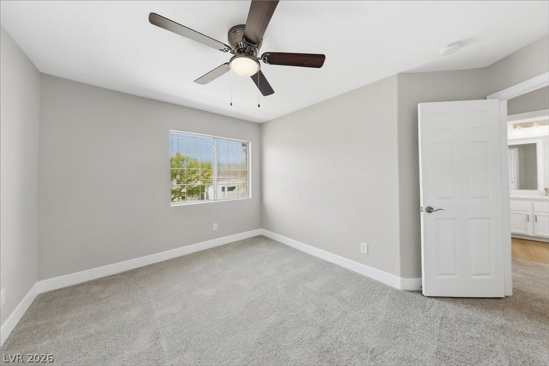 1906 Cardinal Point Street, Henderson, NV 89012 Soft carpeting pairs with a multi-pane window in this comfortable secondary bedroom.