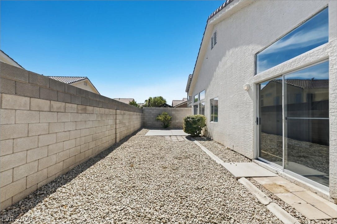 1906 Cardinal Point Street, Henderson, NV 89012 Low-maintenance gravel landscaping lines this private outdoor space enclosed by block fencing.