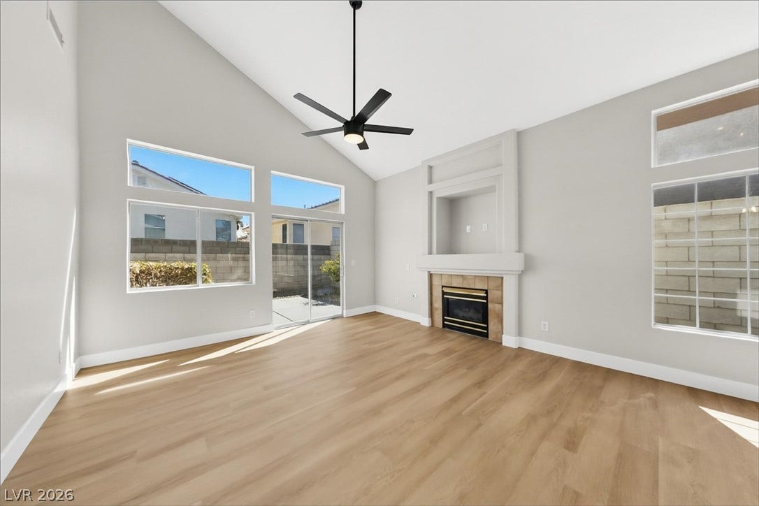 1906 Cardinal Point Street, Henderson, NV 89012 High vaulted ceilings and rich wood-style flooring elevate this comfortable hearthside gathering space.