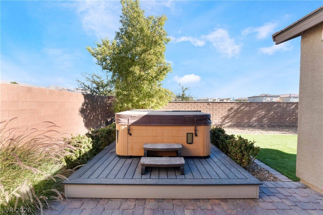 1430 Dire Wolf Avenue, North Las Vegas, NV 89084 A private hot tub rests on a wooden platform within the walled backyard.