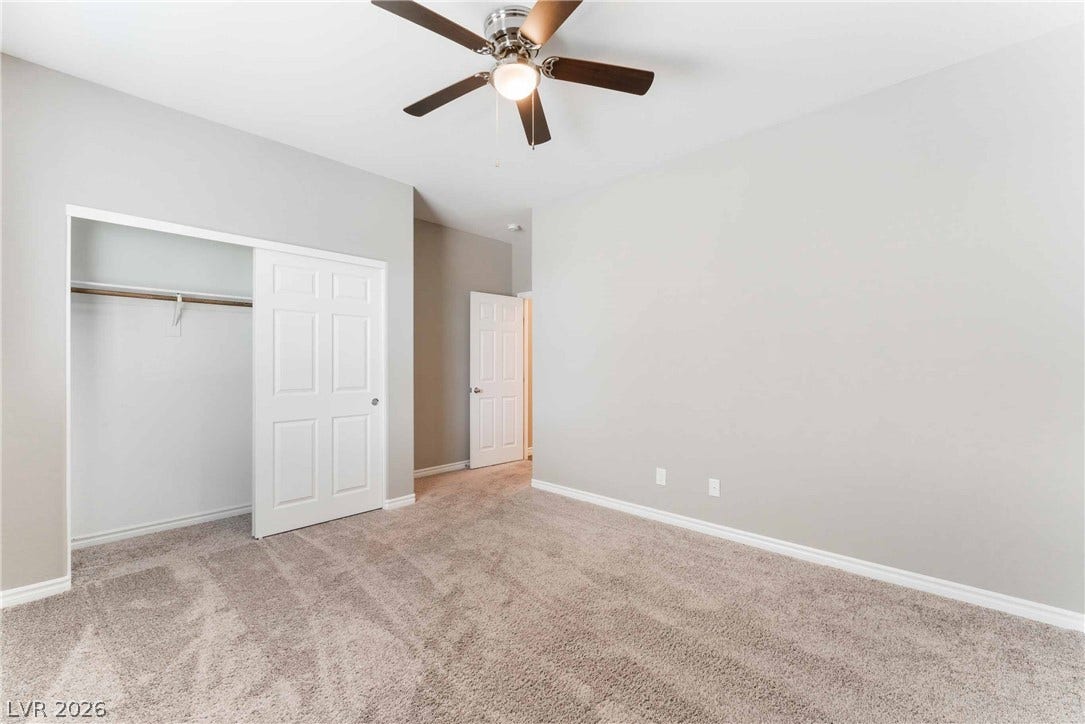 1430 Dire Wolf Avenue, North Las Vegas, NV 89084 Plush carpeting and neutral walls define this versatile bedroom space.