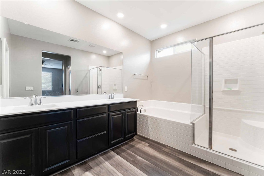 1430 Dire Wolf Avenue, North Las Vegas, NV 89084 A spacious layout highlights the separate soaking tub and glass-enclosed shower.