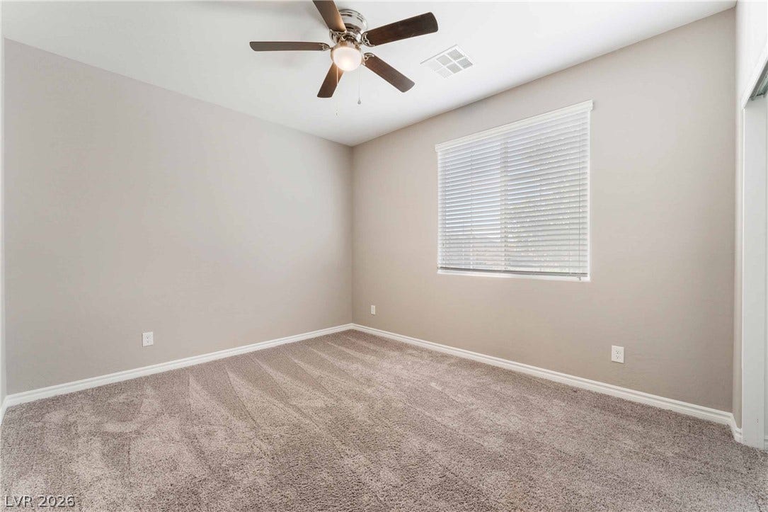 1430 Dire Wolf Avenue, North Las Vegas, NV 89084 Plush carpeting and a large window create a comfortable, inviting atmosphere.