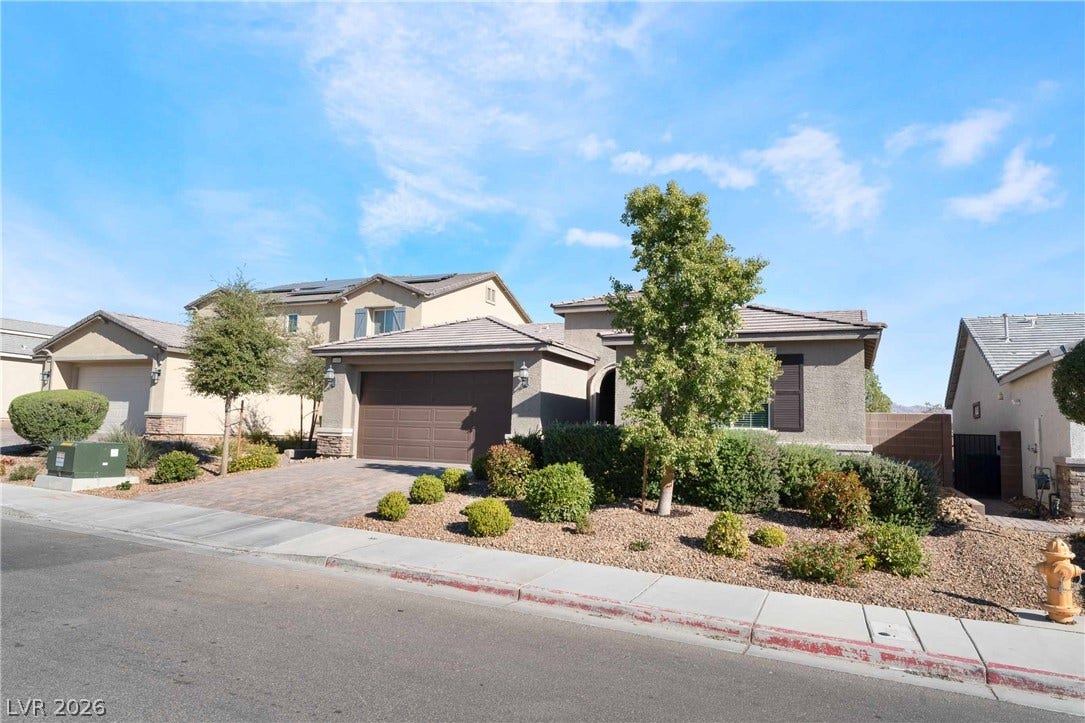 1430 Dire Wolf Avenue, North Las Vegas, NV 89084 Elegant concrete tile roof and manicured desert landscaping define this modern single-story residence.