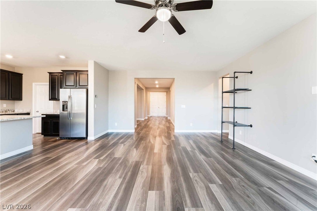 1430 Dire Wolf Avenue, North Las Vegas, NV 89084 Polished wood-look flooring stretches throughout a spacious, fluid layout connects living spaces effortlessly.