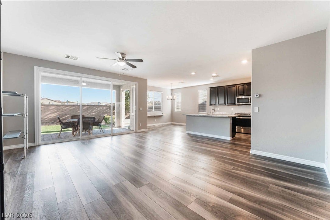 1430 Dire Wolf Avenue, North Las Vegas, NV 89084 Polished hard-surface flooring flows through the open-concept layout connecting the living and kitchen areas.