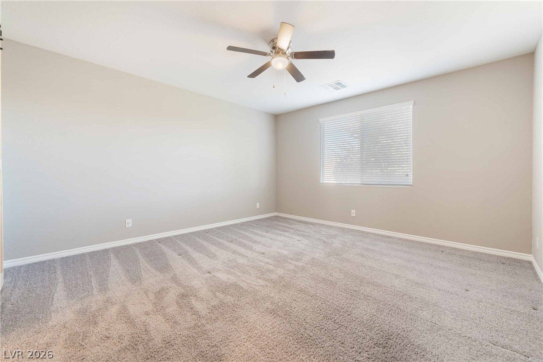 1430 Dire Wolf Avenue, North Las Vegas, NV 89084 Plush wall-to-wall carpeting and clean baseboards define this versatile secondary bedroom space.