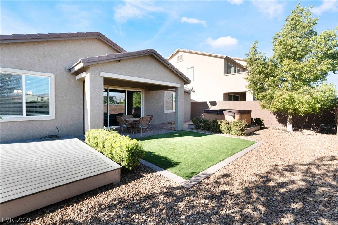 1430 Dire Wolf Avenue, North Las Vegas, NV 89084 A covered patio and low-maintenance turf create an inviting outdoor space.