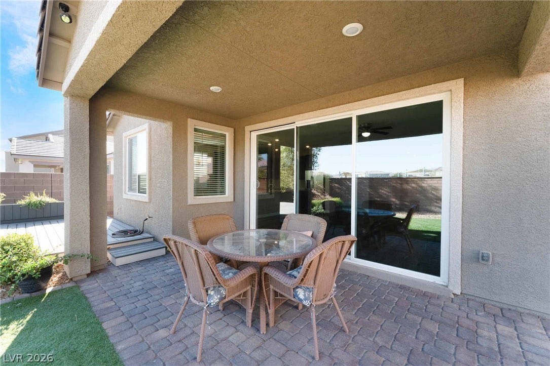 1430 Dire Wolf Avenue, North Las Vegas, NV 89084 An inviting covered patio features a paved floor and a large sliding glass door.