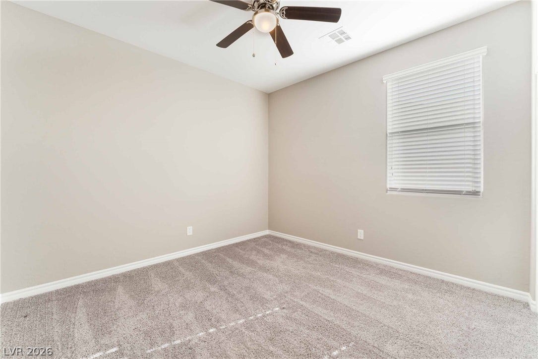 1430 Dire Wolf Avenue, North Las Vegas, NV 89084 Plush carpeting and a large window create a comfortable, inviting atmosphere in this bedroom.