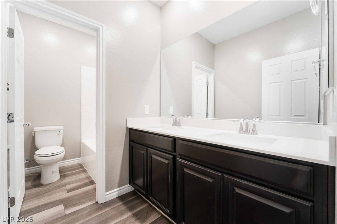 1430 Dire Wolf Avenue, North Las Vegas, NV 89084 Clean lines and a spacious dual vanity define this modern, well-appointed bathroom.
