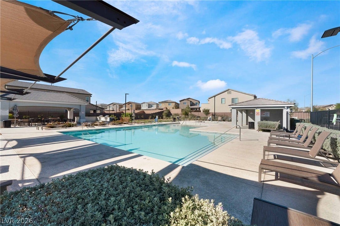 1430 Dire Wolf Avenue, North Las Vegas, NV 89084 A sparkling community pool is framed by spacious concrete decking and shelter structures.