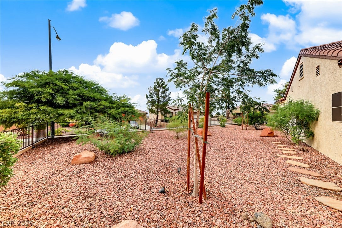 1646 Sebring Hills Drive, Henderson, NV 89052 Low-maintenance desert landscaping frames the side yard of this stucco home.
